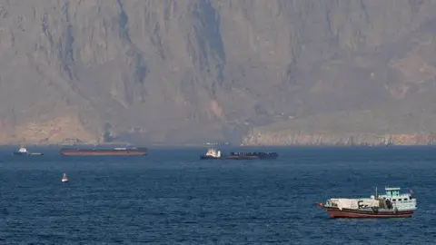 Iran reopens the Strait of Hormuz, but threatens to close it again as the US maintains its blockade